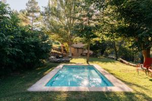 a swimming pool in the middle of a yard at El Molí Nou - Rural flats in Peñarroya de Tastavins