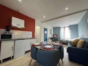 a kitchen and a living room with a table and a couch at C Oslo - Appartement spacieux proche centre-ville in Charleville-Mézières +12 photos