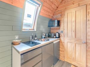 a kitchen with a sink and a counter in a tiny house at Boxing Hare - Uk39915 in Heckington
