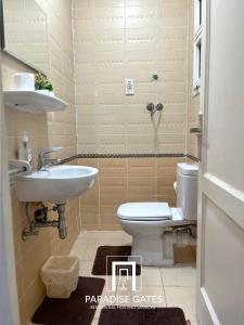 a bathroom with a toilet and a sink at Paradise Gates Madinaty in Madinaty +23 photos
