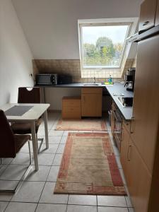 a kitchen with a sink and a table and a window at Ferienwohnung Werne in Werne an der Lippe