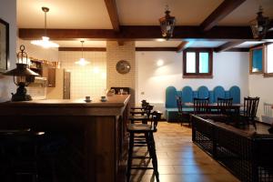 a bar in a restaurant with chairs and a table at Pompei Rooms and Apartment in Pompei