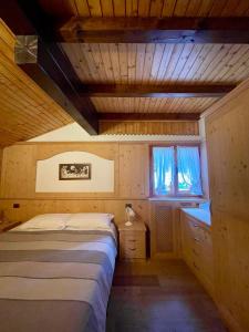 a small bedroom with a bed and a window at Dolomiti Village in Comeglians +59 photos