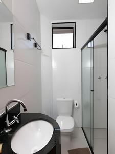 a bathroom with a sink and a toilet at Xavi Studio in Bauru +36 photos