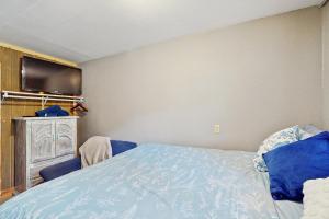 a bedroom with a bed and a flat screen tv at Hickory Hideaway on the Lake in Lake Ozark