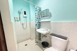 a bathroom with a shower and a toilet and a sink at Scala Hostel in Bangkok +89 photos