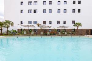 a large swimming pool in front of a building at Residencia Universitaria micampus Murcia in La Ñora
