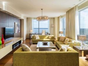 a living room with two couches and a television at Swissotel Tallinn in Tallinn