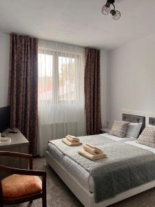a bedroom with two beds and a window at Lili's in Anina +9 photos