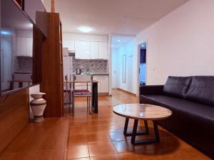 ein Wohnzimmer mit Sofa und Tisch in der Unterkunft Garden City in Playa Fañabe