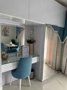 a desk with a blue chair and a mirror at Domina Coral Bay Elisir in Sharm El Sheikh +17 photos