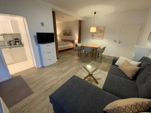 a living room with a couch and a dining room at Schönes Appartement in Neubrandenburg