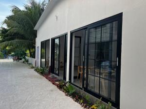 a building with large glass windows on the side of it at Ranveli Dhigurah in Dhigurah