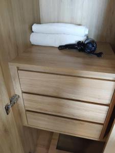 a wooden cabinet with a door with a towel on it at Lemon Apartment Quy Nhơn in Quy Nhon +4 photos