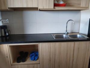 a kitchen with two pairs of shoes in a drawer at Lemon Apartment Quy Nhơn in Quy Nhon
