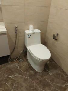 a bathroom with a toilet with a roll of toilet paper at Lemon Apartment Quy Nhơn in Quy Nhon
