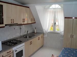 a small kitchen with a sink and a window at Apartamentos Playa Monte Pindo - Lobeira do Mar in O Pindo