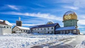 a building with a dome in the snow at Quinta de Natureza in Nabais