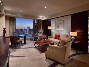 a living room with a couch and a table at Fairmont Beijing - 20 minutes to Forbidden City by metro in Beijing