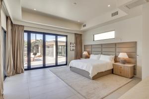 a bedroom with a large bed and a large window at Luxurious Getaway on Lake Havasu Golf Course! in Lake Havasu City +36 photos