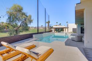 a patio with a swimming pool and two lounge chairs at Luxurious Getaway on Lake Havasu Golf Course! in Lake Havasu City