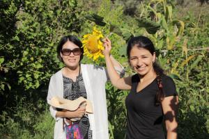 two women are standing next to a sunflower at KiDRAK OTEL MONTENEGRO-1 in Faralya