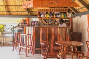 a man and a woman sitting at a bar at The horizon view lodge in Chipata