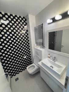 a bathroom with a toilet and a sink and a mirror at City View Apartments in Belgrade +40 photos