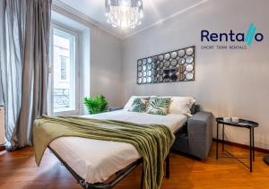 a bedroom with a bed and a large window at Duomo Delight Suite - 200 meters from the Duomo in Milan