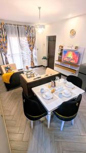 a living room with a table and a couch at GraceApartment in Kampala