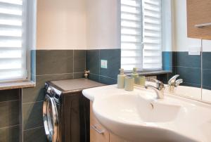 a bathroom with a sink and a washing machine at Traveler's Retreat in Lecco in Lecco