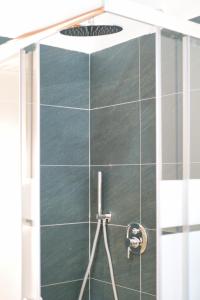 a shower with a glass door in a bathroom at Traveler's Retreat in Lecco in Lecco
