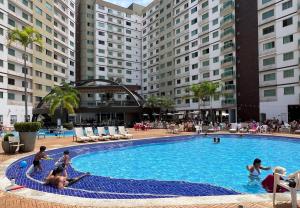 a group of people in a swimming pool at a hotel at Privé Riviera Park Apt 730 in Caldas Novas