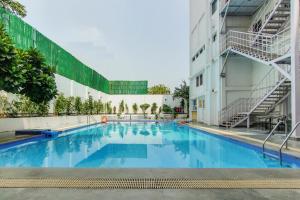 a large swimming pool in the middle of a building at Vibe By The LaLiT Traveller in Faridabad