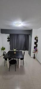 une salle à manger avec une table et des chaises noires dans l'établissement Ocean view two bedroom, 