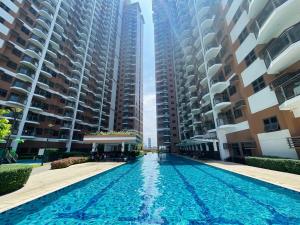 ein Schwimmbad in der Mitte von zwei hohen Gebäuden in der Unterkunft Baylight Studio in Sampong