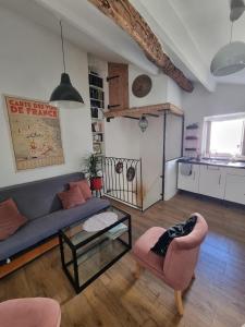 a living room with a couch and a table at Maison de village chaleureuse in La Colle-sur-Loup +19 photos