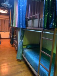 a room with two bunk beds with a tie at RoXx Social Hostel in Bangkok