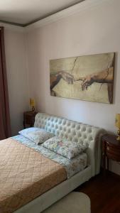a bedroom with a bed and a painting on the wall at Villa Pina b&b in Colleferro +32 photos