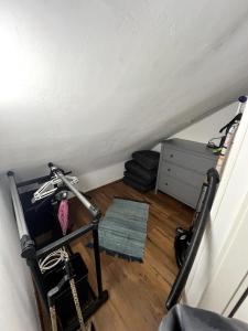 an attic room with a stair case and a room with a room at Gemütliches Apartment Würzburg-Heidingsfeld in Würzburg