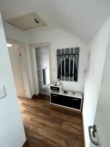 a white bathroom with a sink and a mirror at Gemütliches Apartment Würzburg-Heidingsfeld in Würzburg