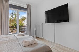a bedroom with a bed with a flat screen tv on a wall at Herbstzeit ist Familienzeit - 180qm für Groß und klein in Bad Wörishofen