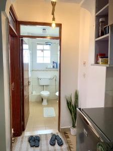 a bathroom with a toilet and a sink at Valentine's Suite in Nairobi