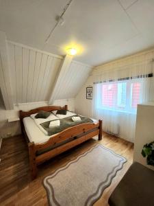 a bedroom with a large wooden bed in a attic at Dali City Senter Ap 2 in Stavanger