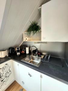 a kitchen with a sink and a counter top at Dali City Senter Ap 2 in Stavanger +15 photos