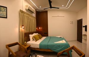 Postel nebo postele na pokoji v ubytování Hotel Elroi Suites