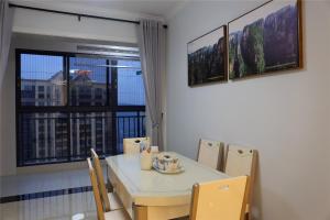 a dining room with a table and chairs and a window at Zhangjiajie 72 Wonder Tower Neighbour's House in Zhangjiajie
