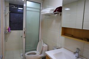 a bathroom with a toilet and a sink and a shower at Zhangjiajie 72 Wonder Tower Neighbour's House in Zhangjiajie