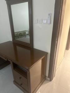 a dressing table with a mirror on top of it at روضة السقيا in Quai +3 photos