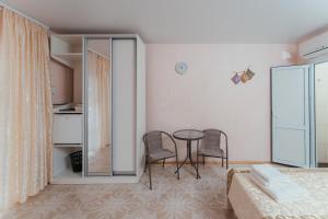 a room with a bed and a table and chairs at Aura in Zatoka +47 photos